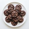 A plate of chocolate cookies with milk chocolate chips